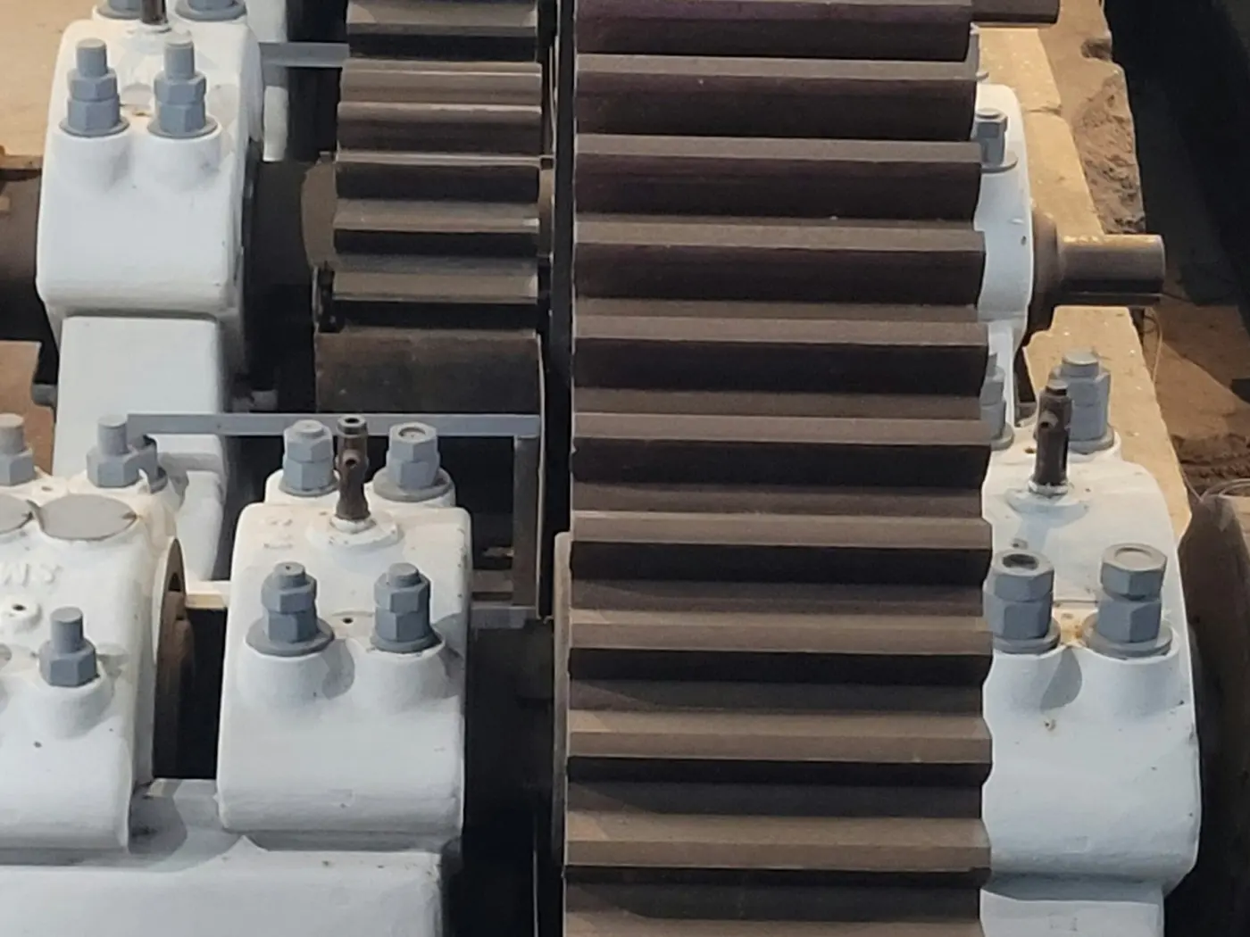 Large spur gears meshing inside an industrial drive unit